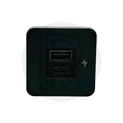 Front view of charging socket with one USB-A port, one USB-C port, and lightning symbol on black panel.