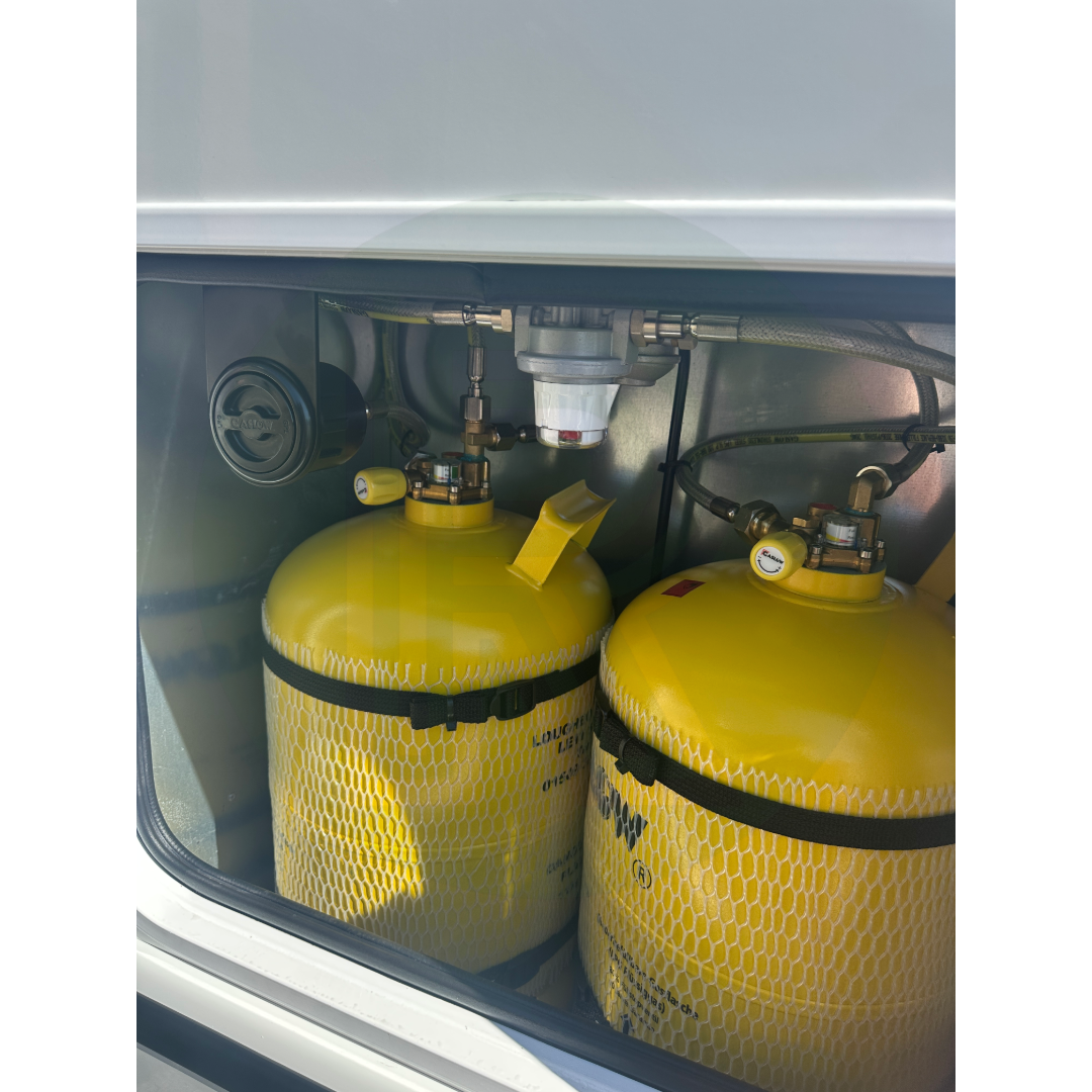 Gaslow in-locker refillable LPG cylinder kit installed in a motorhome gas locker with twin refillable gas bottles, automatic changeover regulator and in-locker filling point.