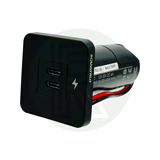 Angled view of dual USB-C socket showing front panel and housing with wiring.